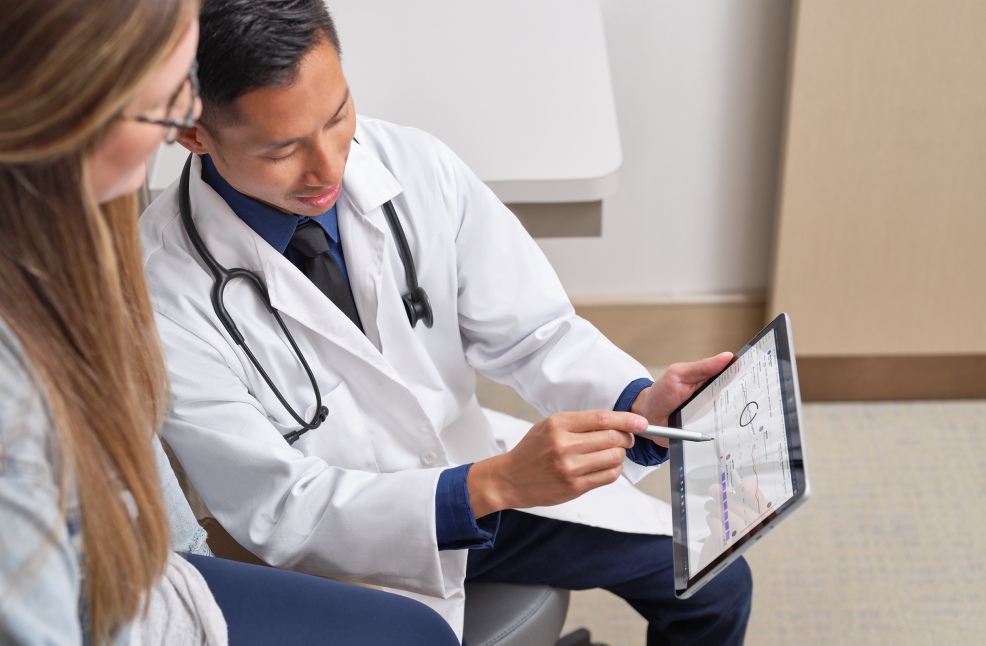 asian doctor explaining data on a tablet