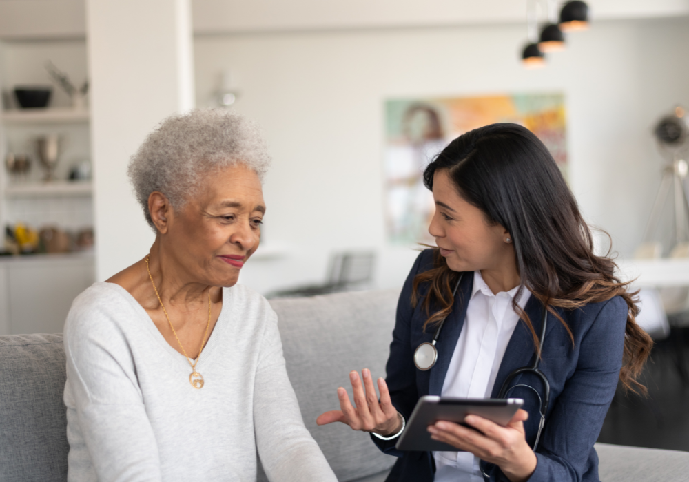 asian female doctor consulting a mature black woman