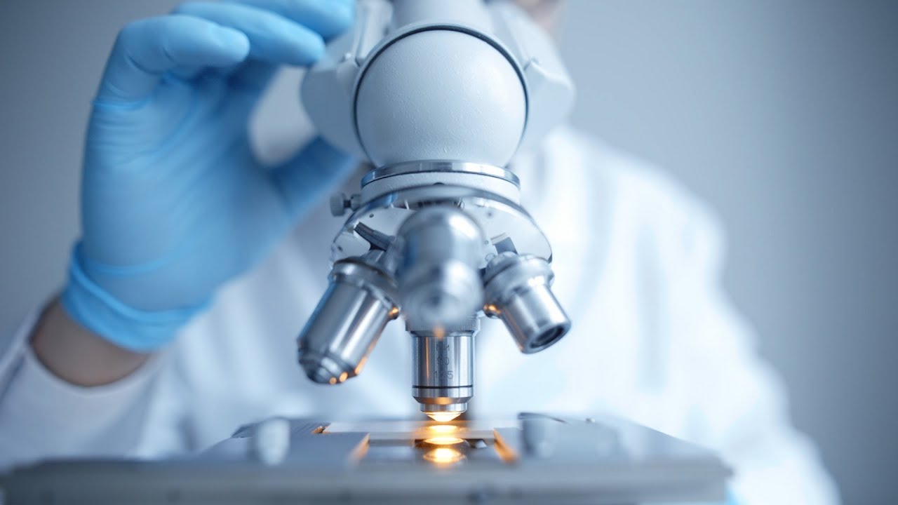 a scientist looking through a microscope